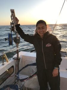 Naomi Jainarine holding plankton sampler at sea